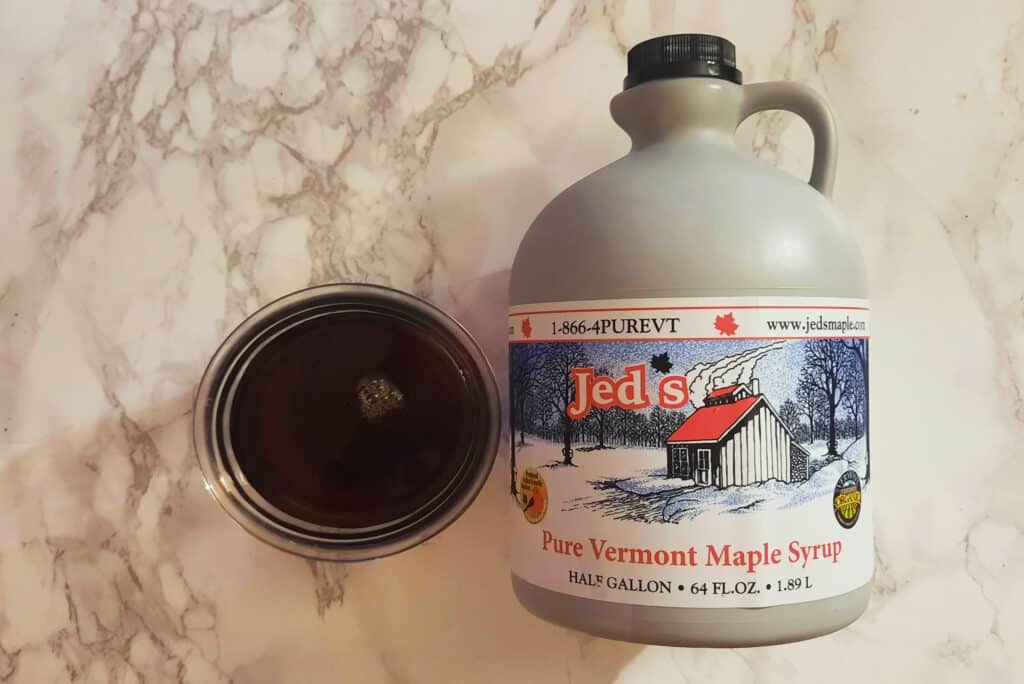 Vermont-maple-syrup-half-gallon-container-and-bowl-of-poured-dark-robust-syrup