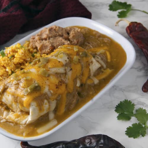 burrito-smothered-in-cheese-and-Denver-green-chile-sauce-with-beans-and-rice