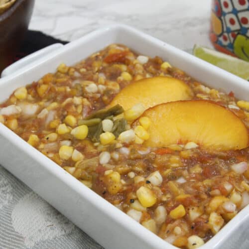 closeup-of-Colorado-salsa-garnished-with-palisade-peaches-olathe-sweet-corn-and-pueblo-green-chiles-in-rectangular-white-dish