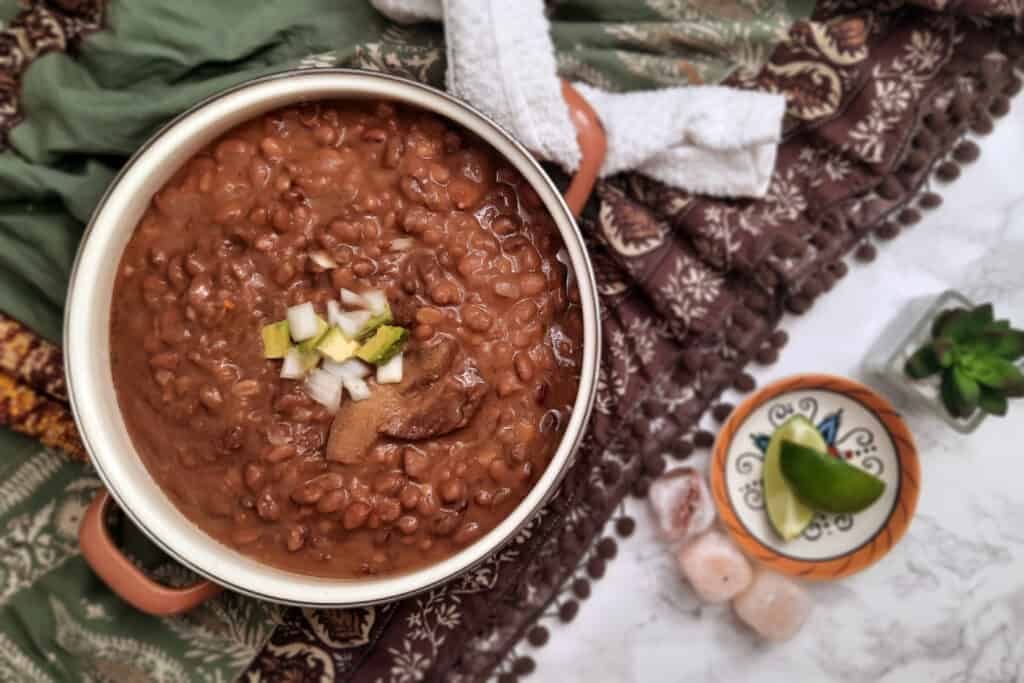 large-pot-southwestern-style-Trading-Post-Beans-pinto-bean-dish-garnished-with-avocado-onion-and-salt-pork