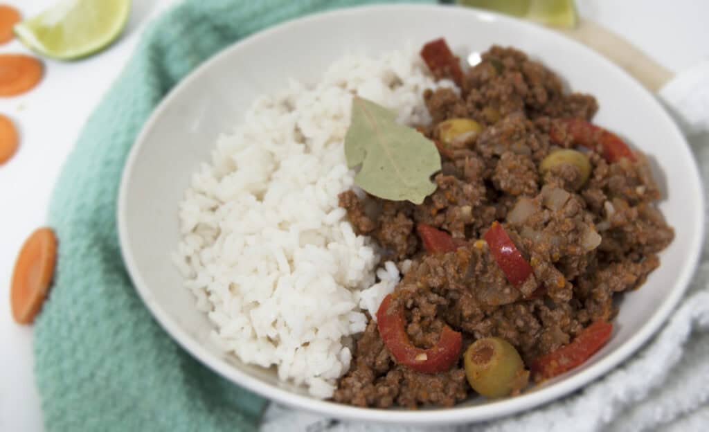 bowl-of-Cuban-picadillo-and-white-rice-garnished-with-bay-leaf