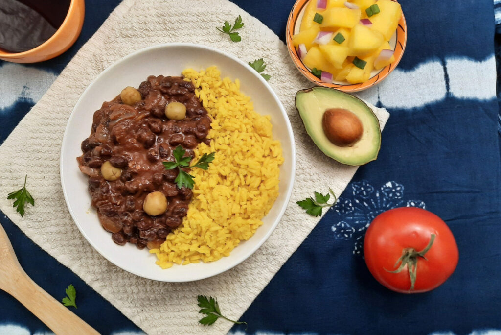 Cuban-black-beans-frijoles-negros-top-view-served-with-authentic-yellow-rice