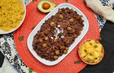 Frijoles-negros-Cuban-black-beans-top-view-white-plate-garnished-with-red-onions