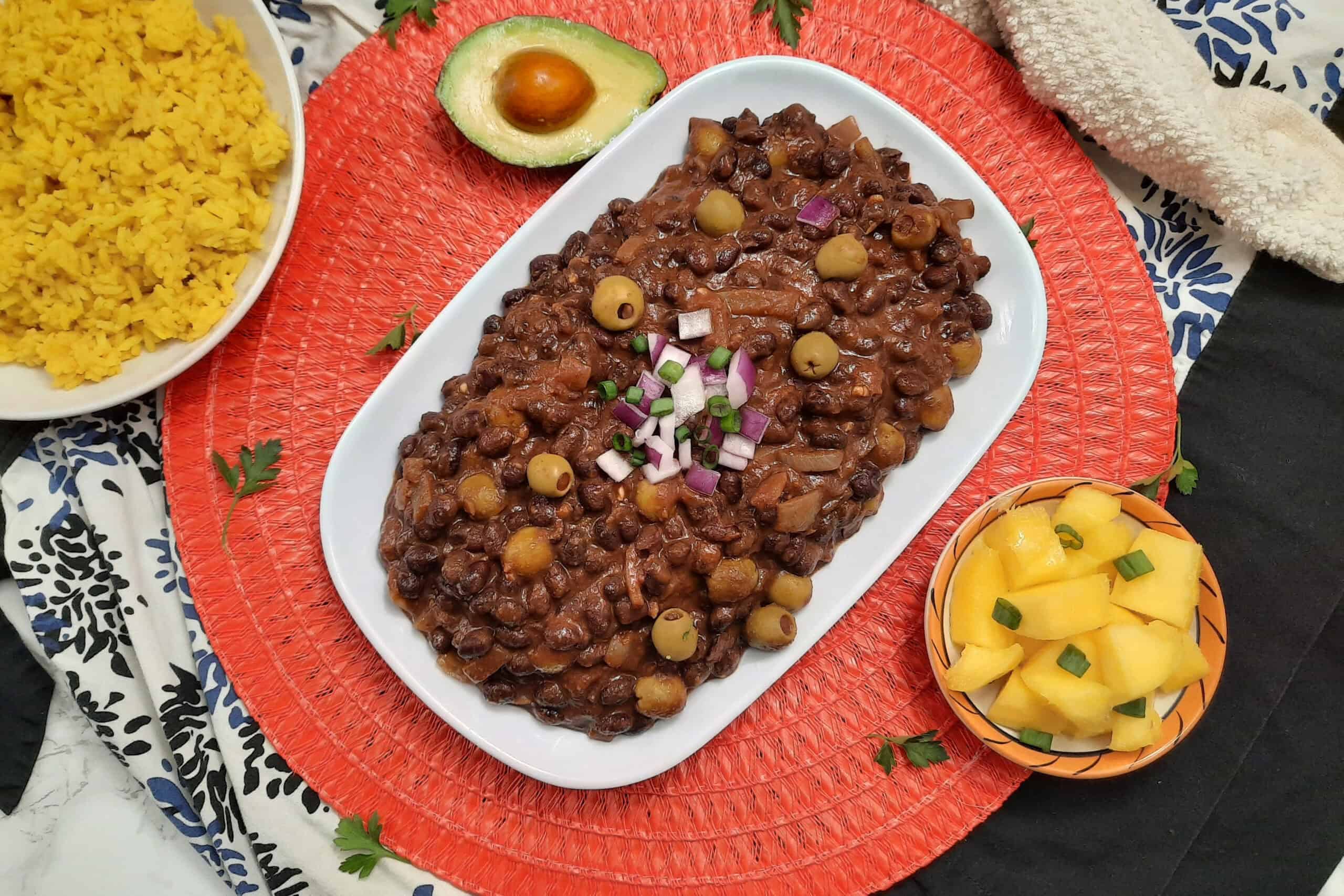 Frijoles-negros-Cuban-black-beans-top-view-white-plate-garnished-with-red-onions