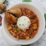 serving-dish-of-Fricasé-de-pollo-Cuban-chicken-fricassee-with-two-drumsticks-and-white-rice