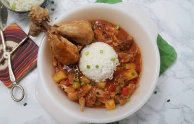 serving-dish-of-Fricasé-de-pollo-Cuban-chicken-fricassee-with-two-drumsticks-and-white-rice