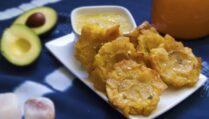 six-stacked-Cuban-tostones-con-mojo-on-white-plate-garnished-with-salt