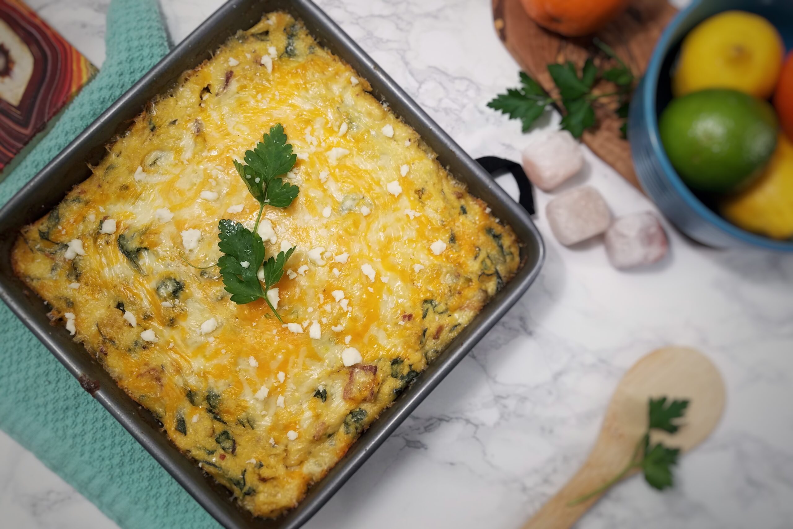 top-view-breakfast-polenta-casserole-in-baking-pan-garnished-with-crumbled-cheese-and-parsley