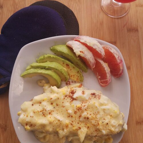 top-view-paprika-garnished-creamed-eggs-on-toast-served-with-sliced-avocado-and-grapefruit