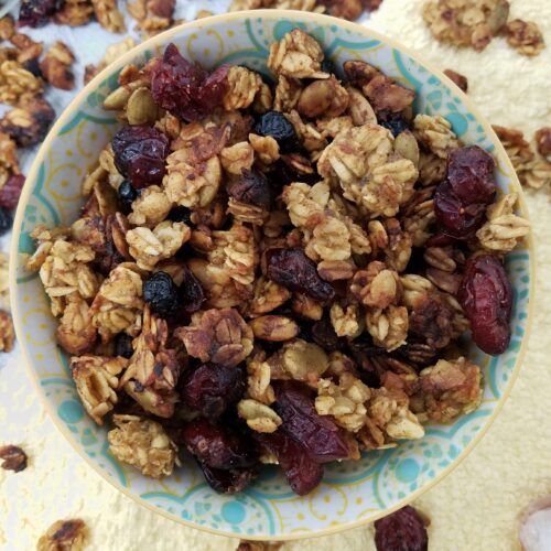 top-view-allergy-free-granola-carmelized-banana-orange-chai-in-pastel-bowl