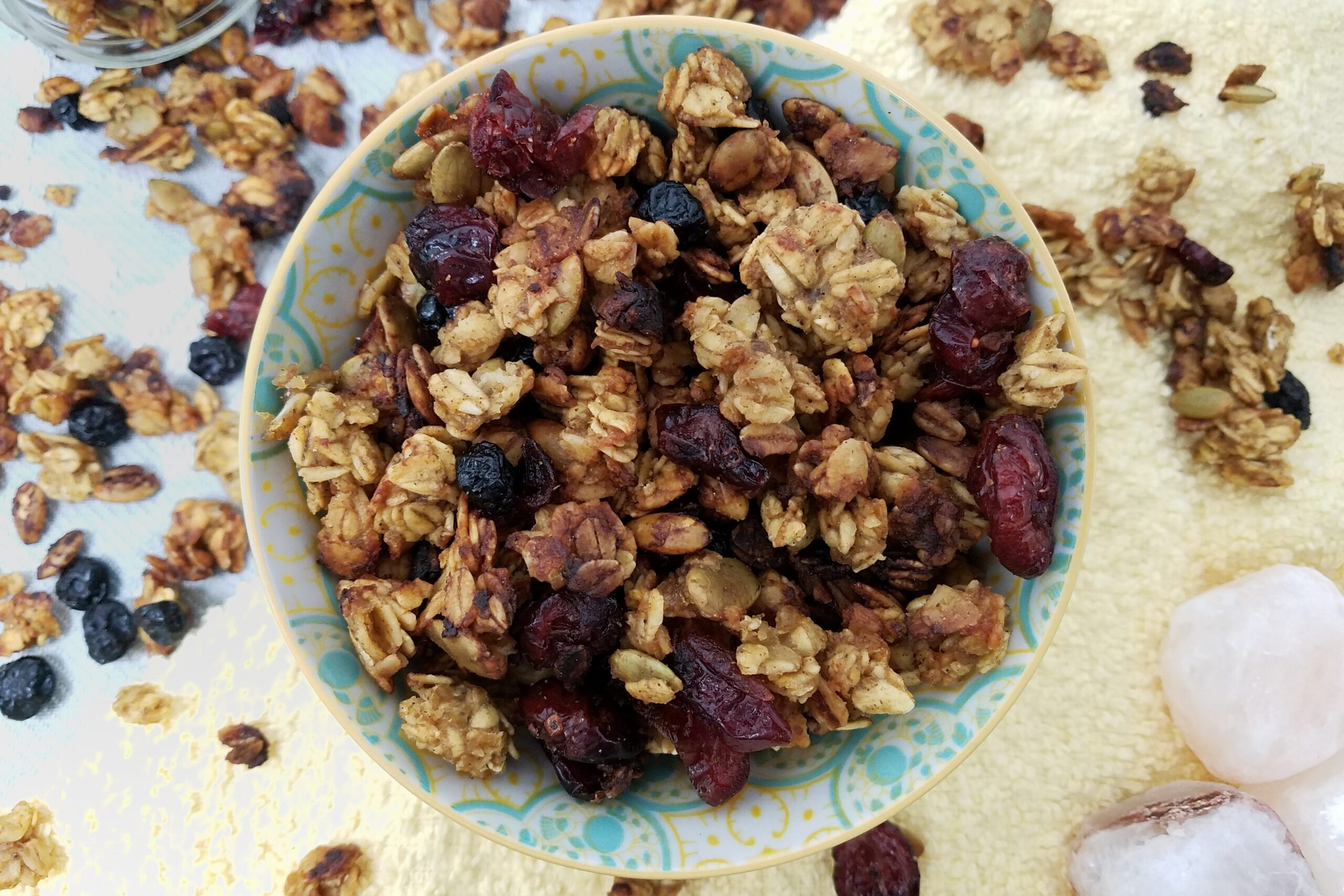 top-view-allergy-free-granola-carmelized-banana-orange-chai-in-pastel-bowl