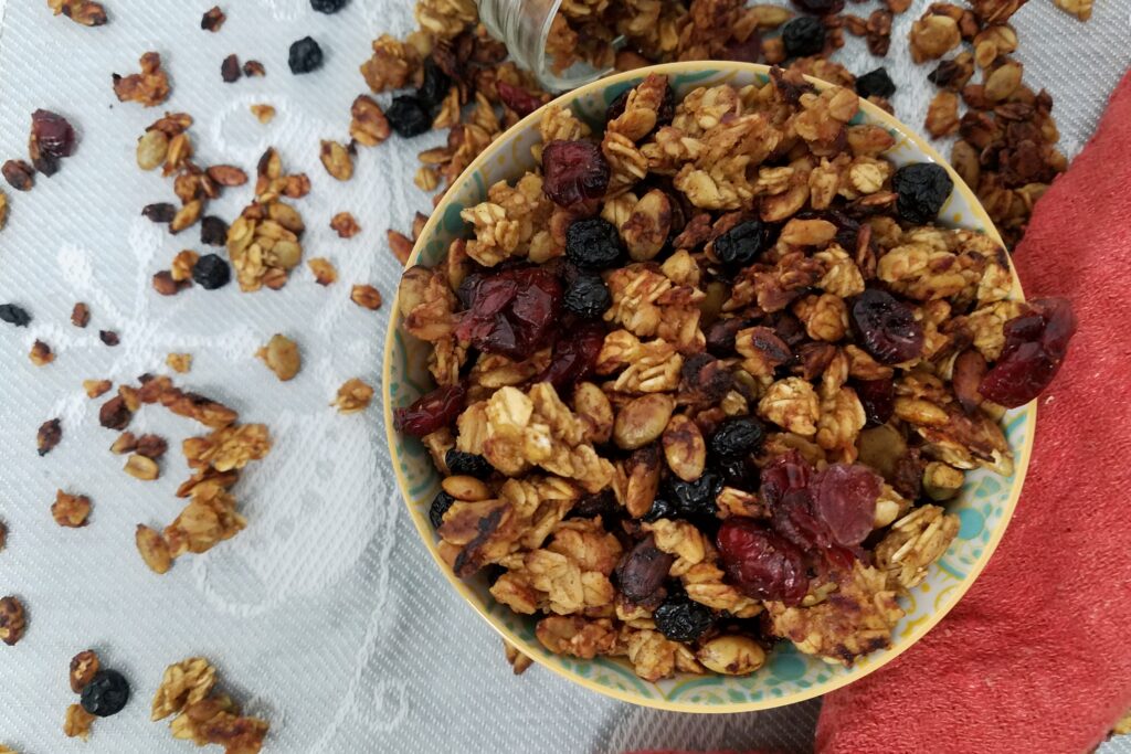 blue-yellow-bowl-filled-with-allergy-free-granola-with-white-and-red-tablecloth