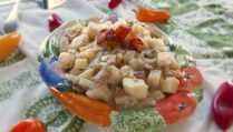 Kartoffelsalat-German-potato-salad-served-in-garden-vegetable-themed-porcelain-dish-garnished-with-bacon