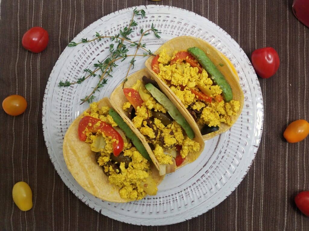 three-corn-tortilas-filled-with-avocado-and-mediterranean-tofu-scramble-with-artichokes-olives-and-peppers