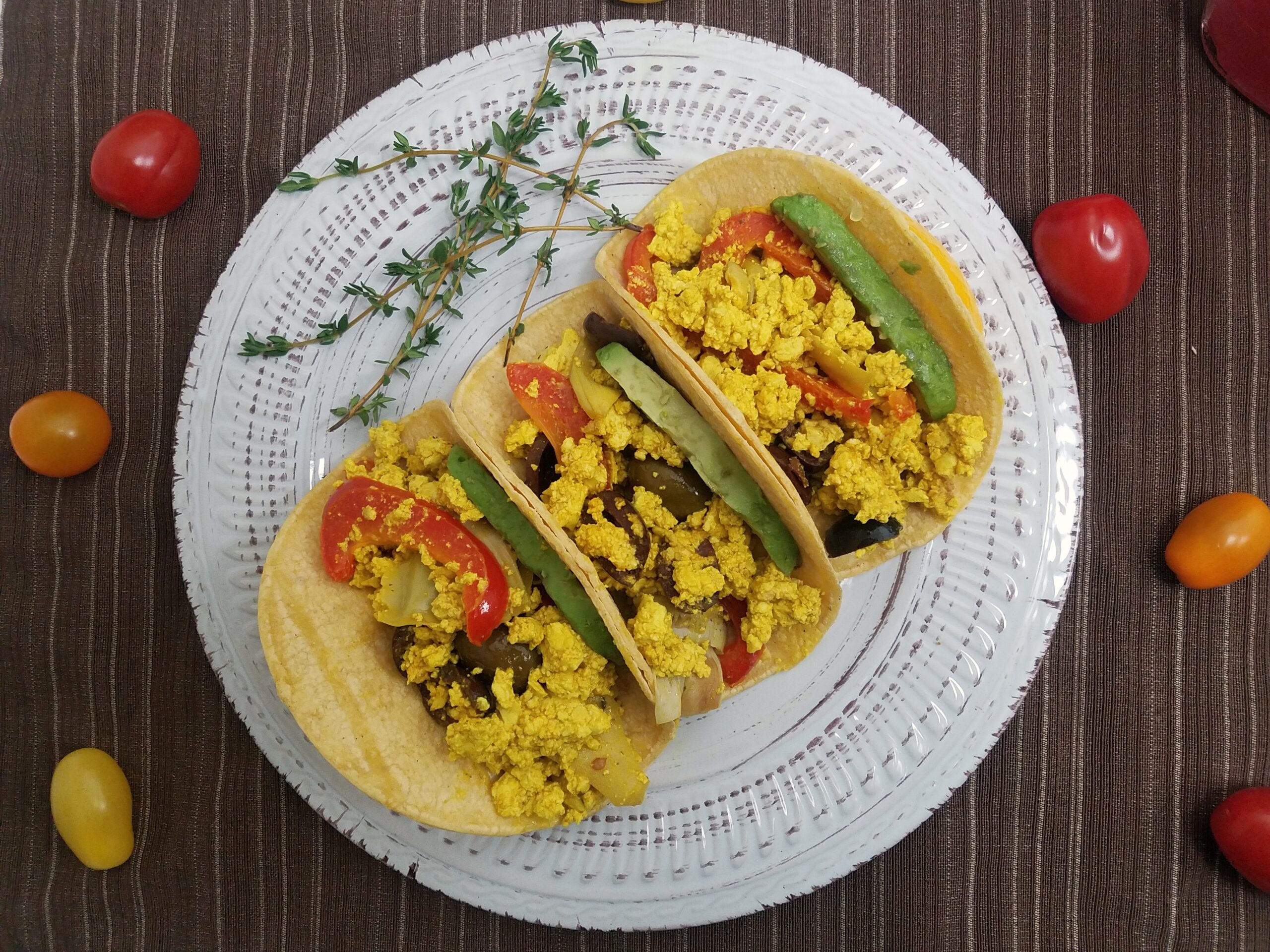 three-corn-tortilas-filled-with-avocado-and-mediterranean-tofu-scramble-with-artichokes-olives-and-peppers