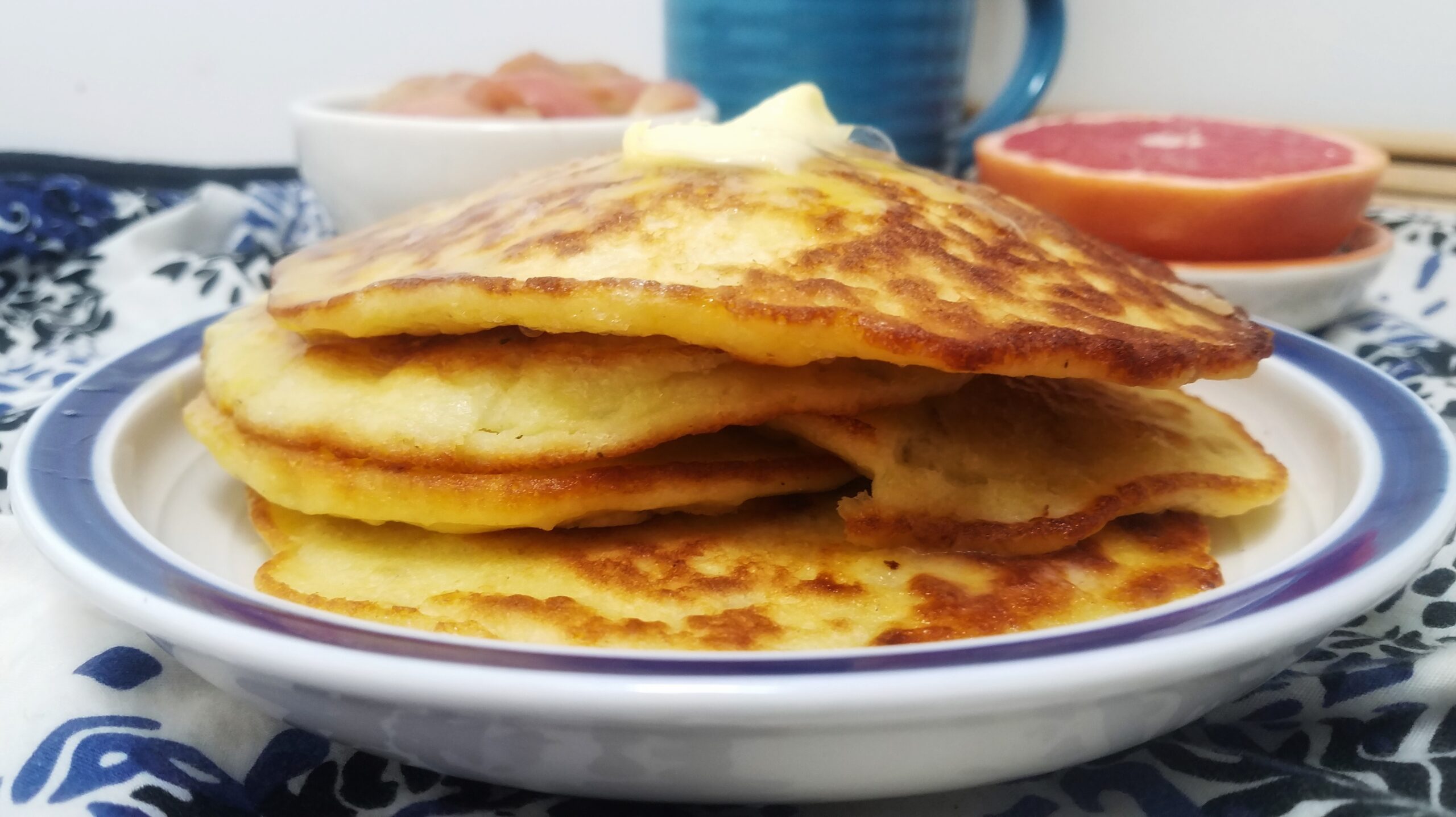 side-view-four-stacked-potato-pancakes-topped-with-melted-butter