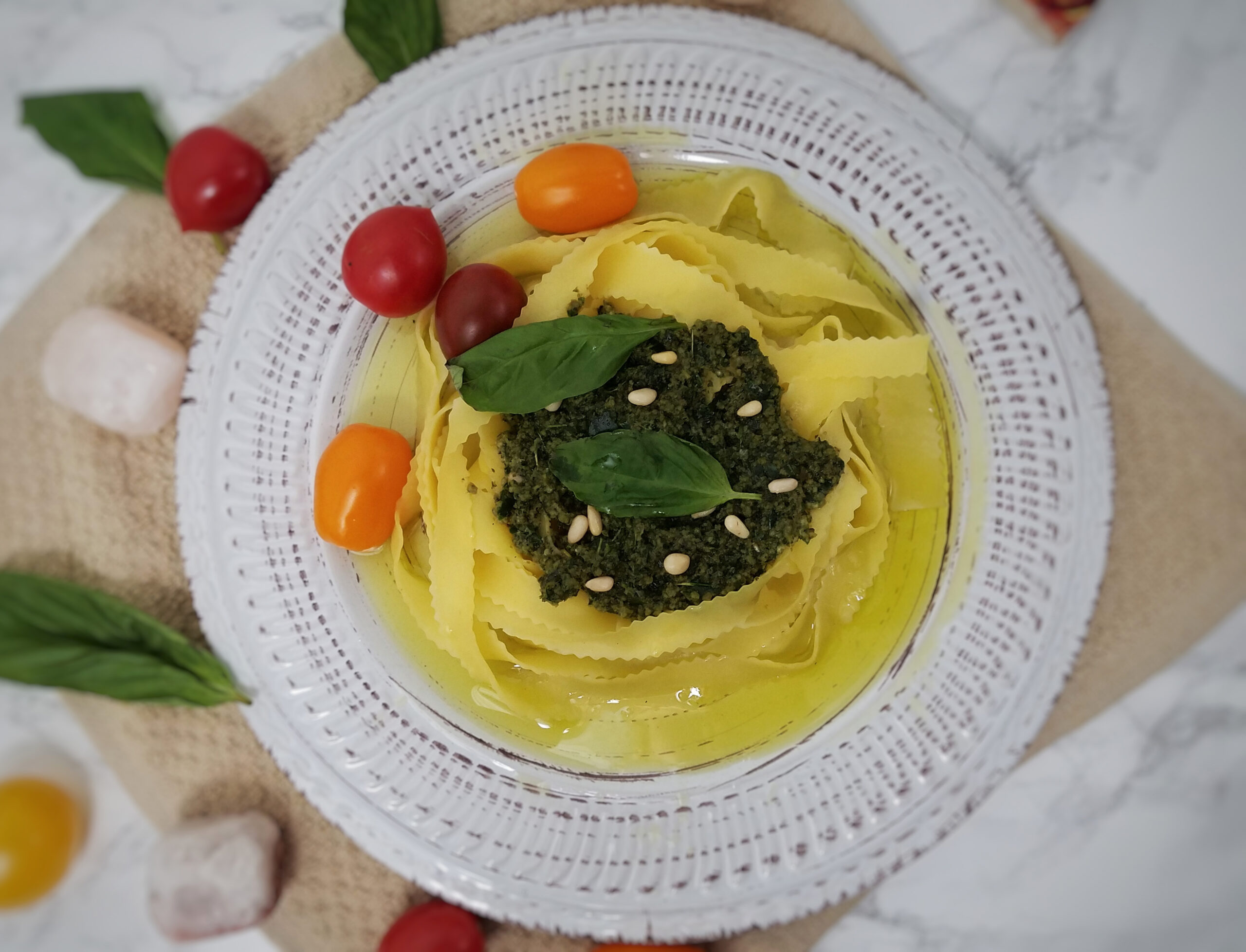 egg-noodles-topped-with-kaffir-basil-pesto-garnished-with-leftover-kaffir-lime-leaves-and-tomatoes