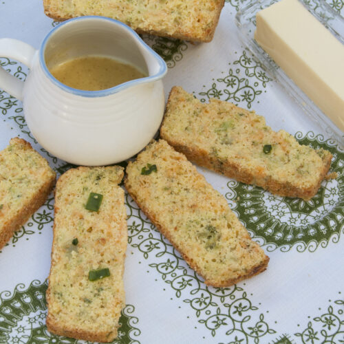 four-slices-broccoli-cheese-bread-surrounding-small-pot-of-honey-mustard