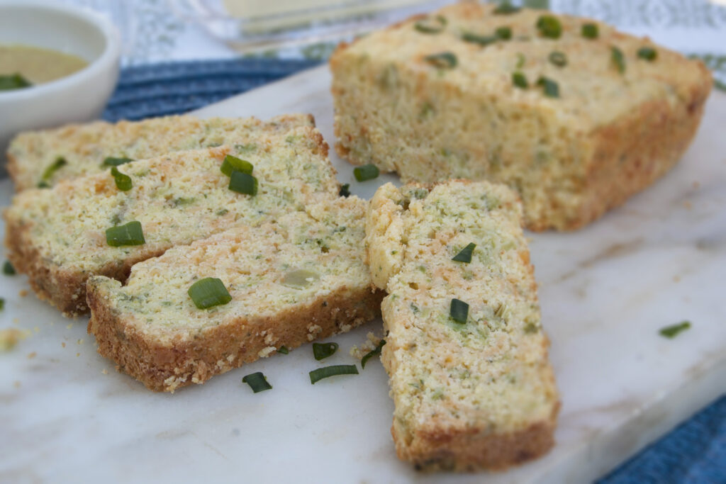 closeup-broccoli-cheddar-cheese-bread-sliced-on-marble-serving-platter