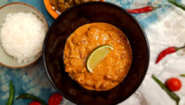 top-view-jain-vegetarian-rajma-garnished-with-lime-wedge-served-in-brown-bowl