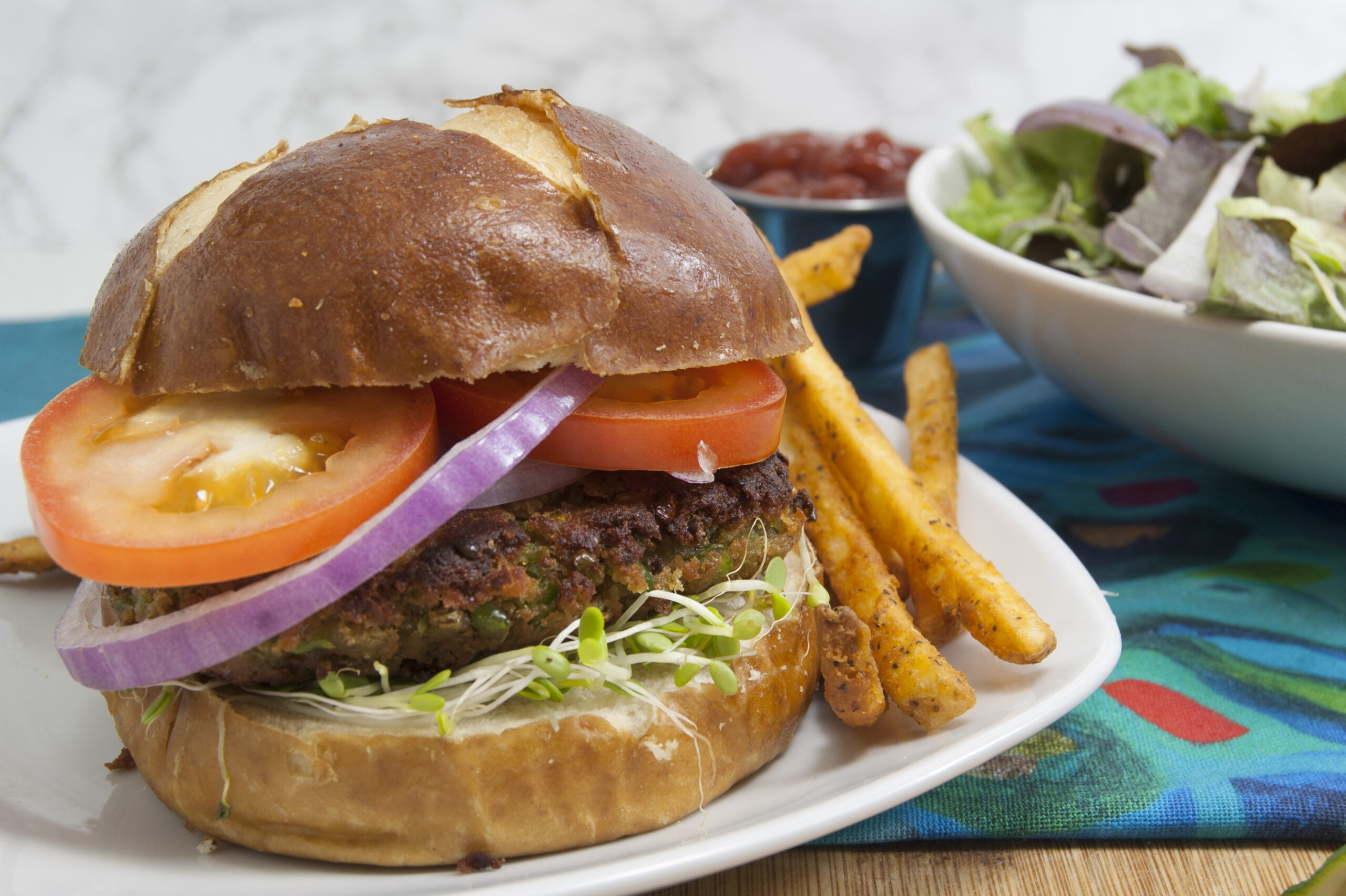 black-eyed-pea-unique-veggie-burger-recipe-served-on-bun-on-white-plate-with-fries