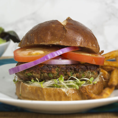 black-eyed-pea-burger-on-brioche-bun-with-tomatoes-red-onions-sprouts-and-fries