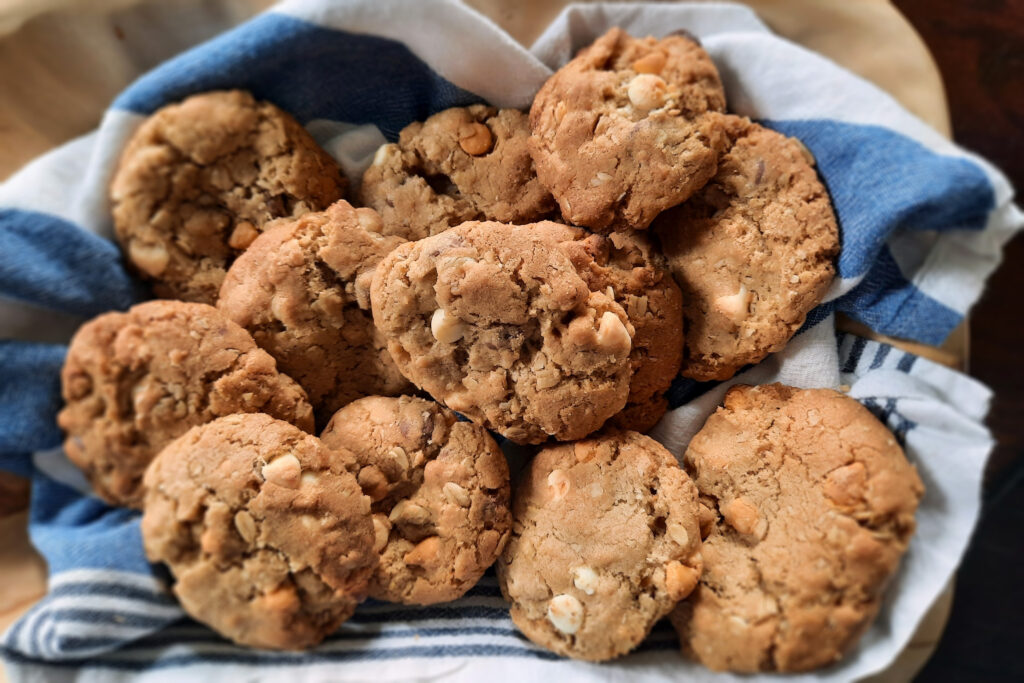 top-view-oatmeal-triple-chip-cookies-in-basket-with-blue-white-linen