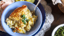 single-serving-Swedish-corn-pudding-garnished-with-green-onions-in-blue-bowl