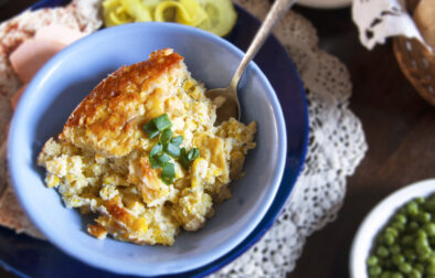 single-serving-Swedish-corn-pudding-garnished-with-green-onions-in-blue-bowl