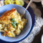 single-serving-Swedish-corn-pudding-garnished-with-green-onions-in-blue-bowl