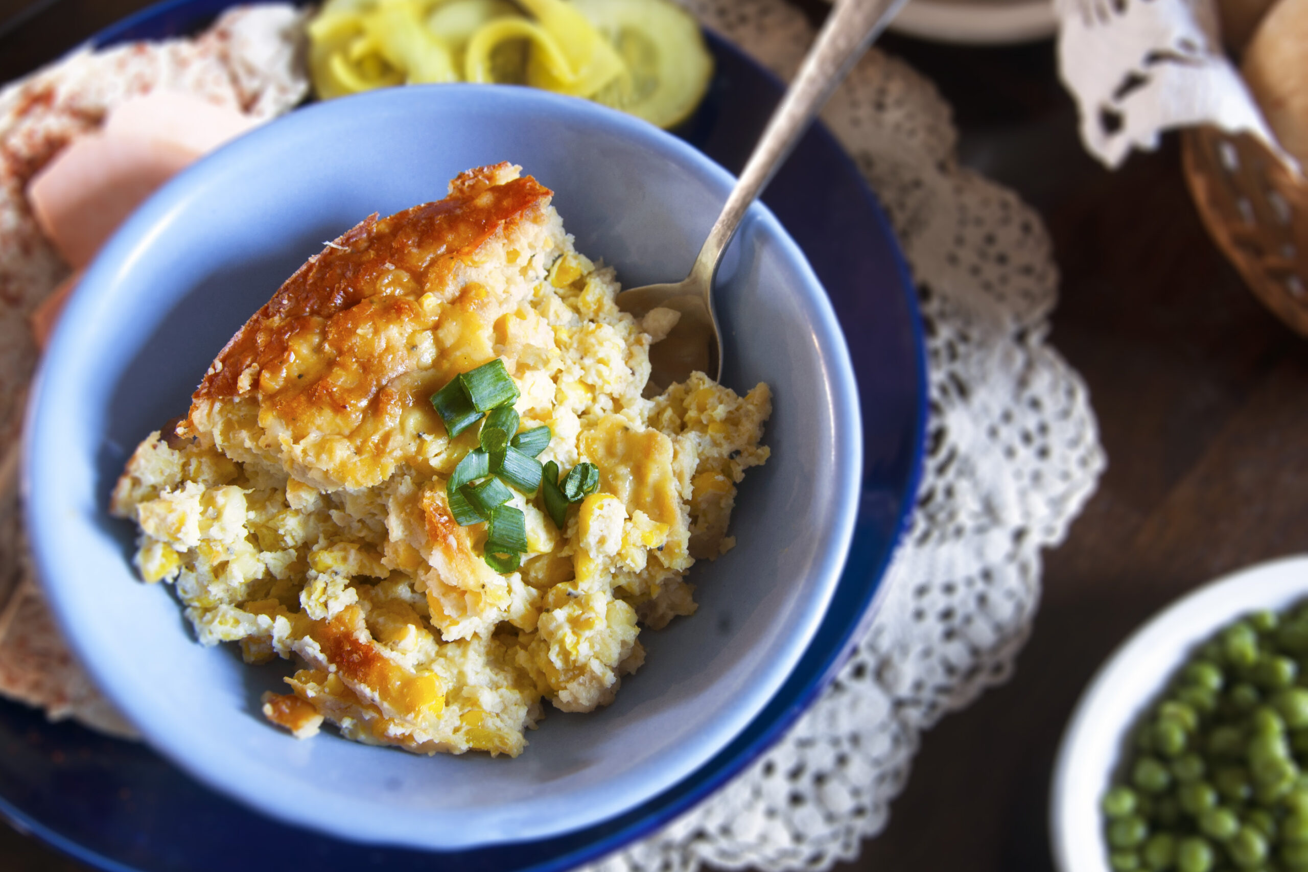 single-serving-Swedish-corn-pudding-garnished-with-green-onions-in-blue-bowl