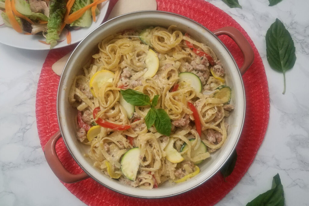 top-view-fettuccine-with-sausage-and-vegetables-squash-zucchini-bell-pepper-and-white-sauce