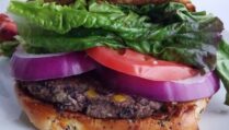 Ultimate-veggie-burger-best-black-bean-patties-served-on-bun-with-lettuce-tomatoes-and-onion