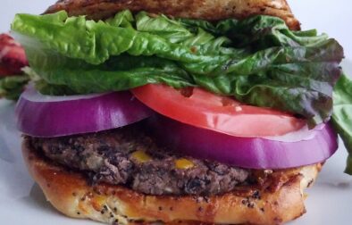 Ultimate-veggie-burger-best-black-bean-patties-served-on-bun-with-lettuce-tomatoes-and-onion