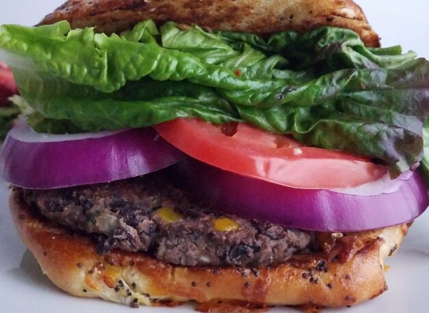 Ultimate-veggie-burger-best-black-bean-patties-served-on-bun-with-lettuce-tomatoes-and-onion