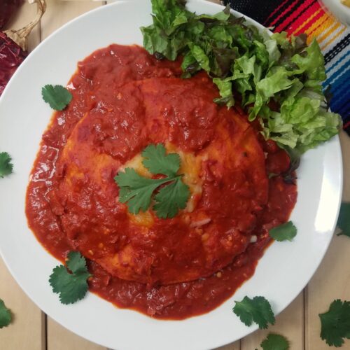 New-Mexican-style-stacked-enchiladas-with-red-sauce-on-white-plate-garnished-with-cilantro