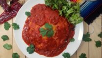 New-Mexican-style-stacked-enchiladas-with-red-sauce-on-white-plate-garnished-with-cilantro