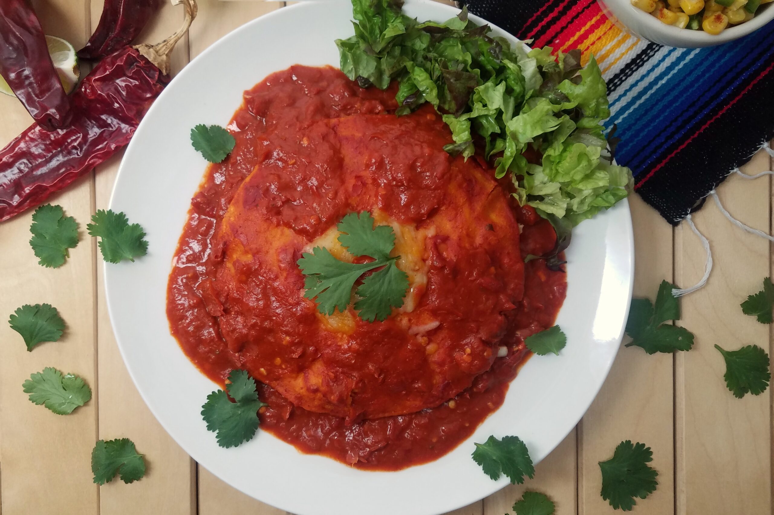 New-Mexican-style-stacked-enchiladas-with-red-sauce-on-white-plate-garnished-with-cilantro