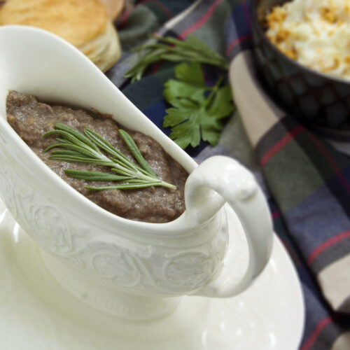 white-dish-with-ultra-umami-mushroom-gravy-garnished-with-rosemary-served-with-biscuits