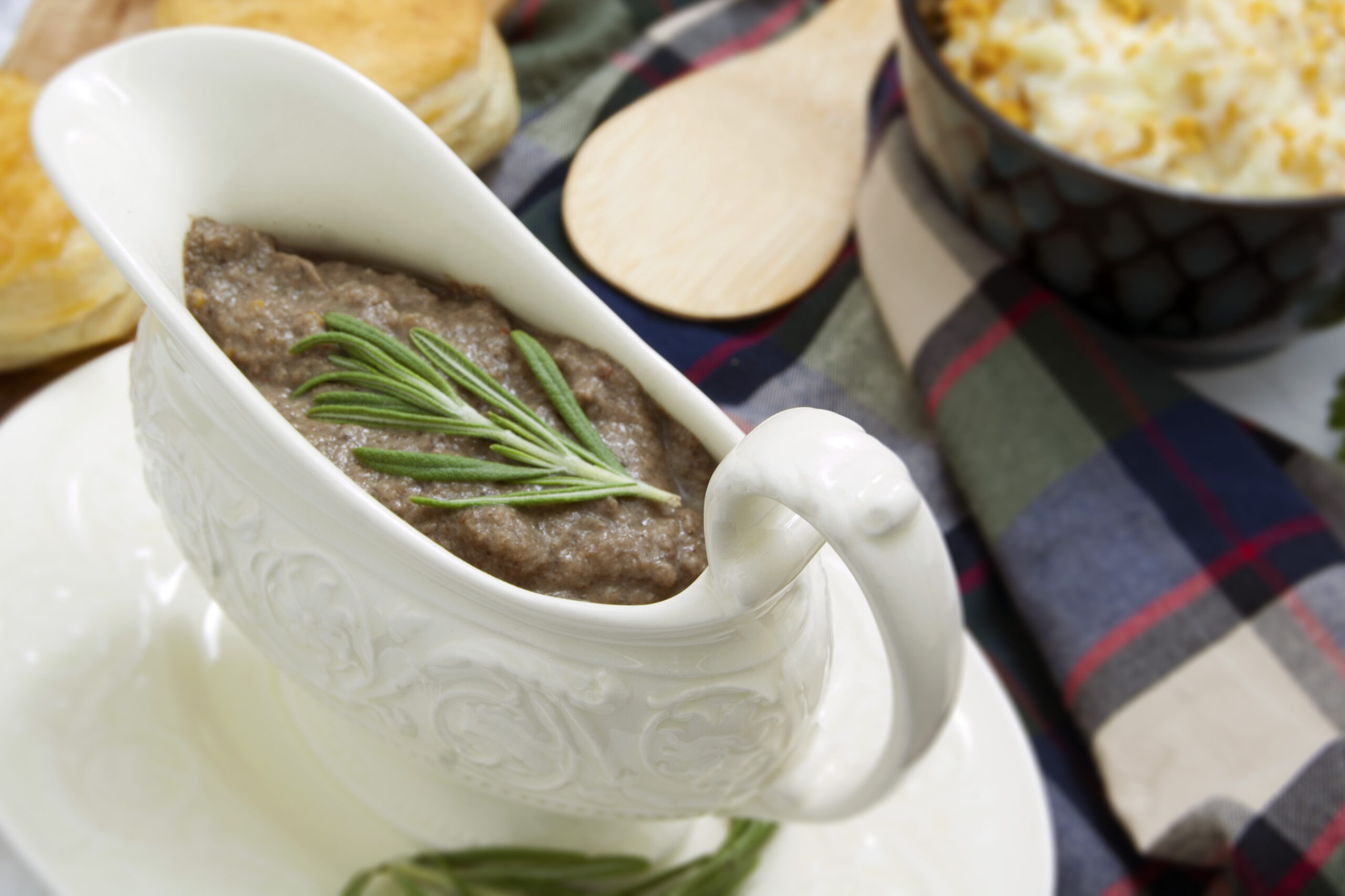 white-dish-with-ultra-umami-thick-mushroom-gravy-garnished-with-rosemary-served-with-biscuits