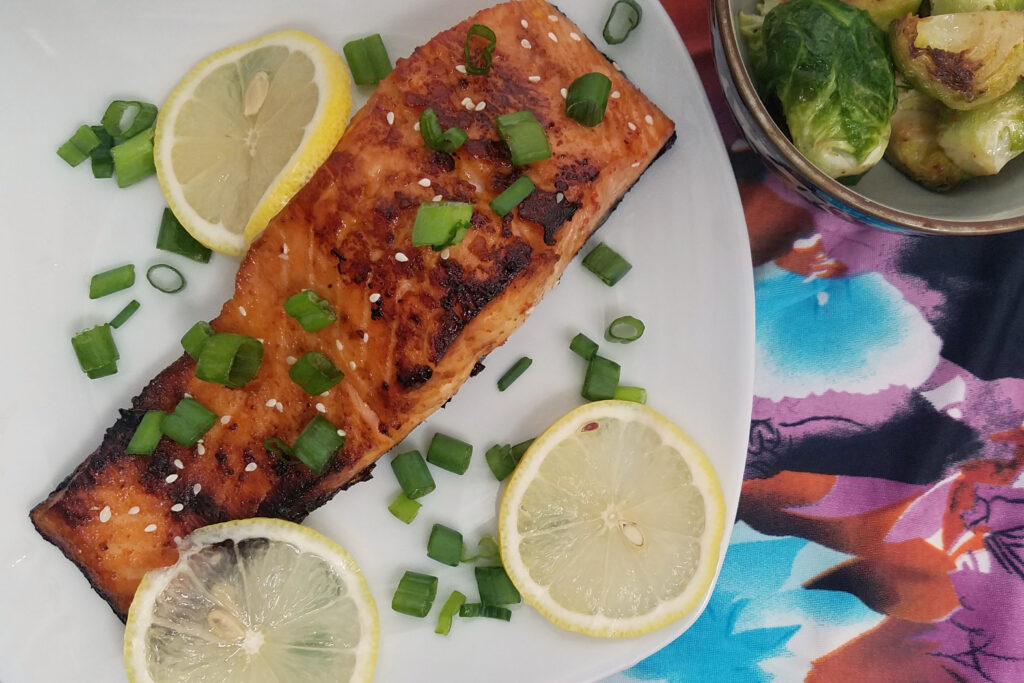 hoisin-maple-oven-salmon-portion-garnished-with-lemons-and-green-onions