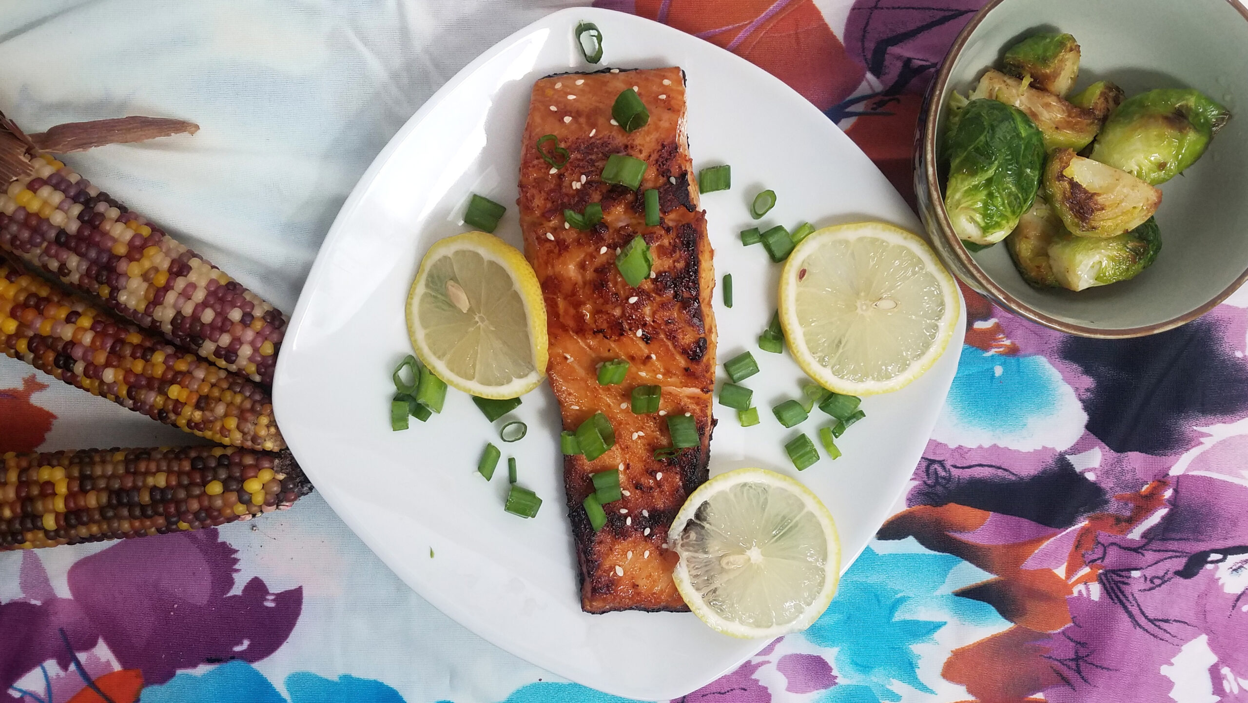 seared-and-baked-portion-hoisin-maple-salmon-served-with-brussels-corn-lemons-and-chives