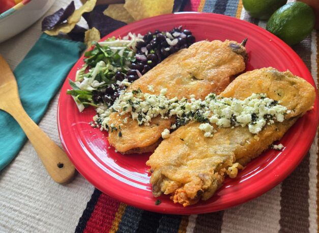 New-Mexican-style-chiles-rellenos-made-with-Hatch-chile-peppers-served-with-side-of-beans