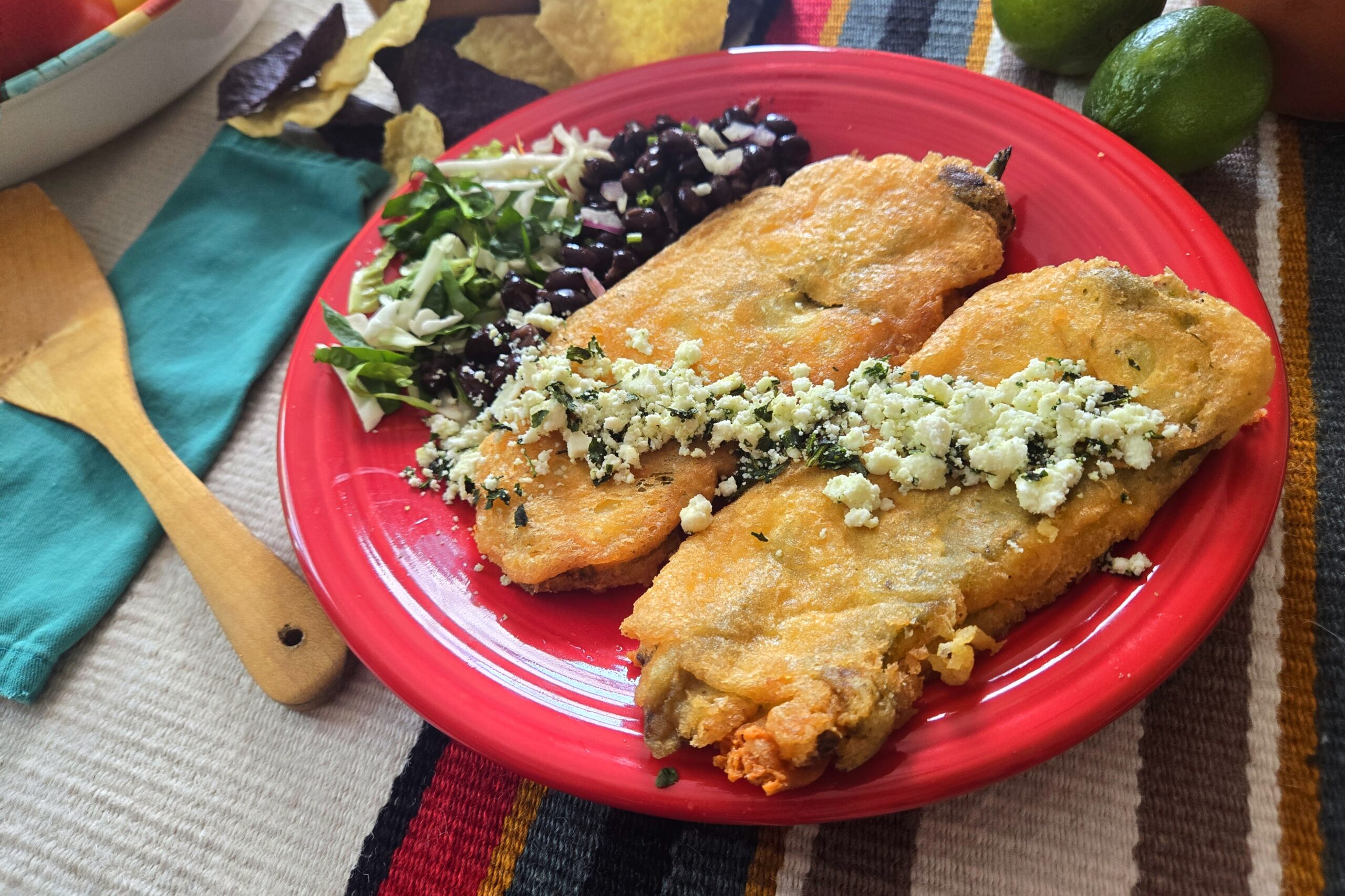 New-Mexican-style-chiles-rellenos-made-with-Hatch-chile-peppers-served-with-side-of-beans