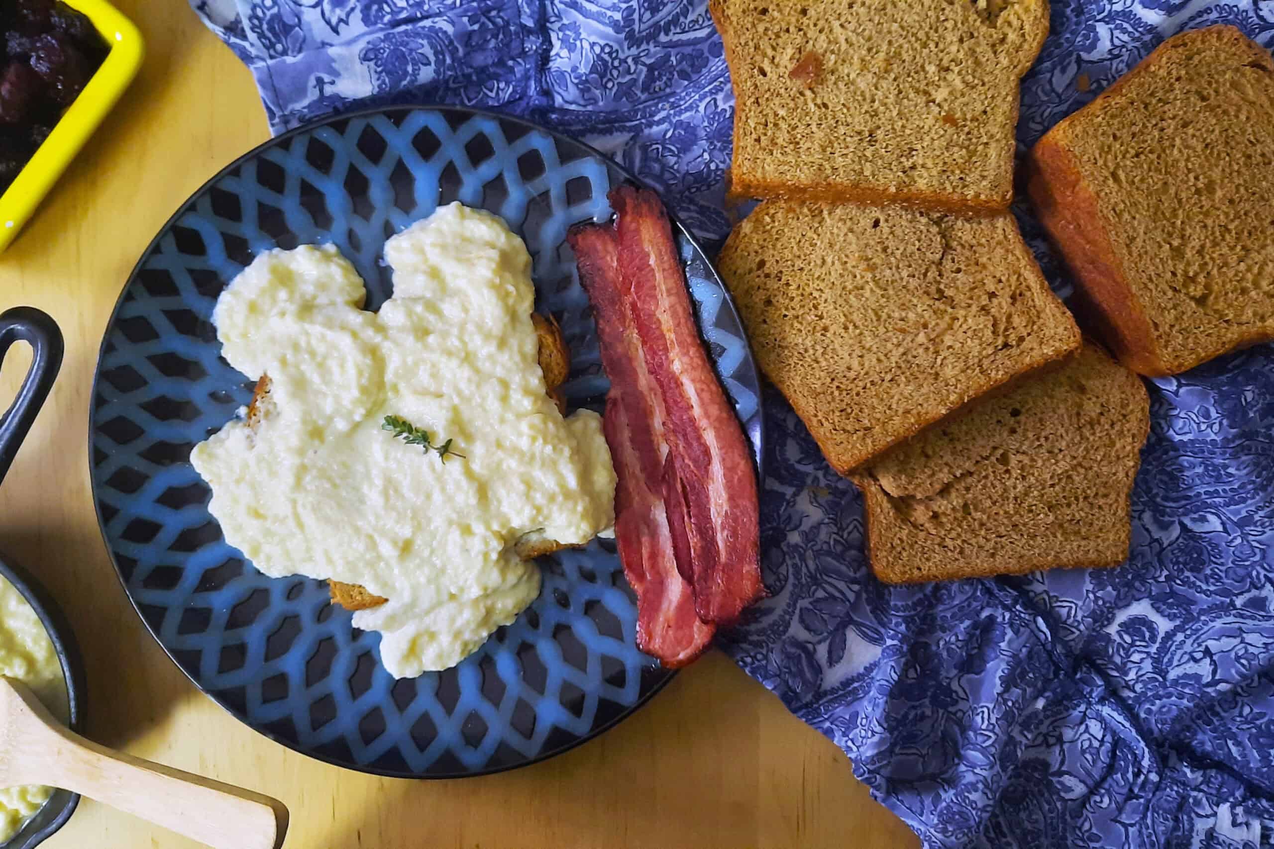 top-view-Swedish-egg-gravy-on-rye-bread-served-with-bacon-on-blue-plate